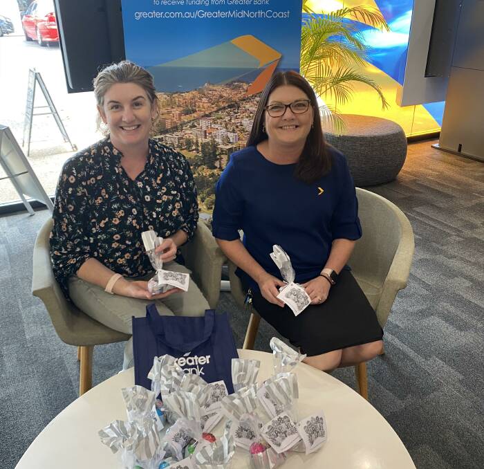 Libby Ryan from Cerebral Palsy Alliance receiving the Easter gifts from Greater Banks Port Macquarie Branch Manager, Leanne Dunlop.
