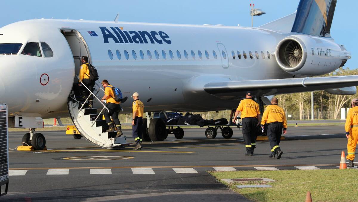 Good luck: RFS crews board the plane at Port Macquarie airport. Photo: NSW Rural Fire Service - Mid Coast District.