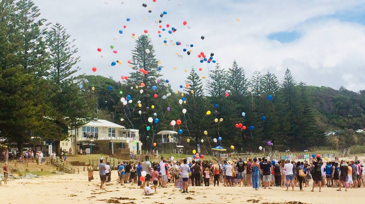 Final farewell: Family and friends held a memorial service for Bronson Rhodes on Flynns Beach. Photo: Supplied
