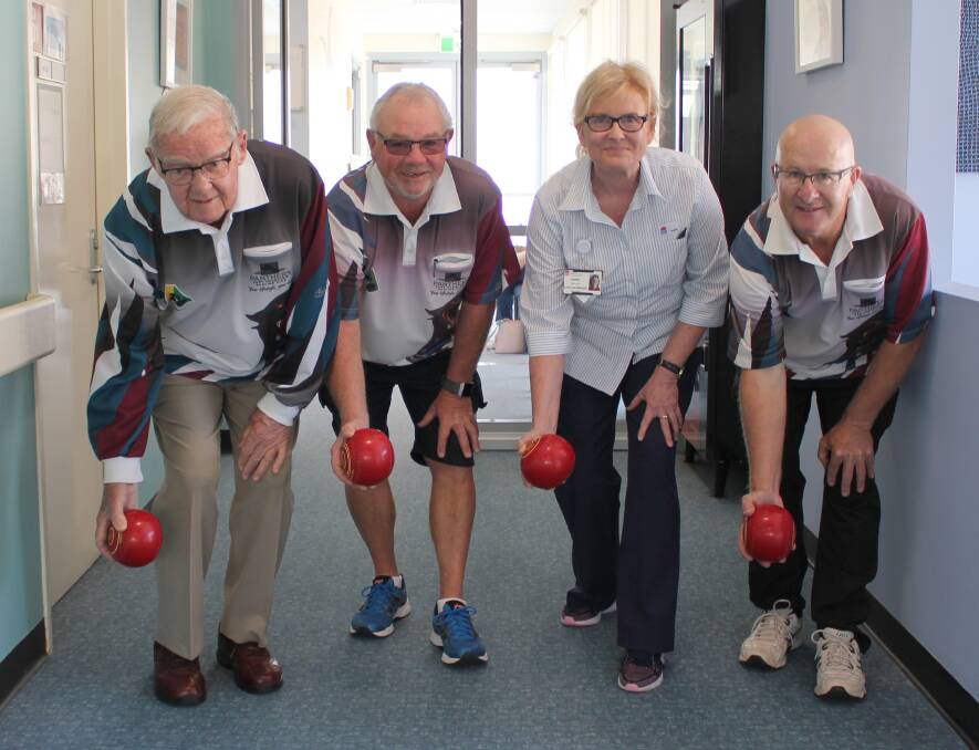 Roll 'em up: Club Patron Keith Uptin, President John Wright and Secretary Darrel Foster with Mid North Coast Cancer Institute Nurse Unit Manager Jenny Baroutis.