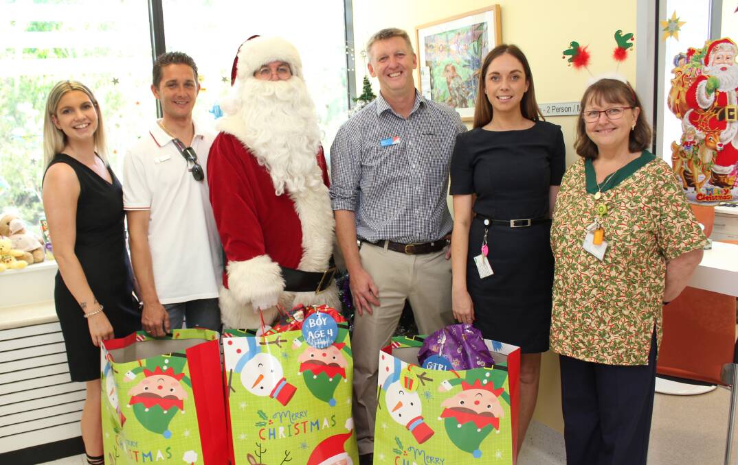 Miedecke Motor Group’s Michellie Henry and Josh Little (left) and Settlement City’s Brett Varcoe and Erin Schmidt with special guest Santa and a delighted Paediatric Nursing Unit Manager, Nicole Leith.