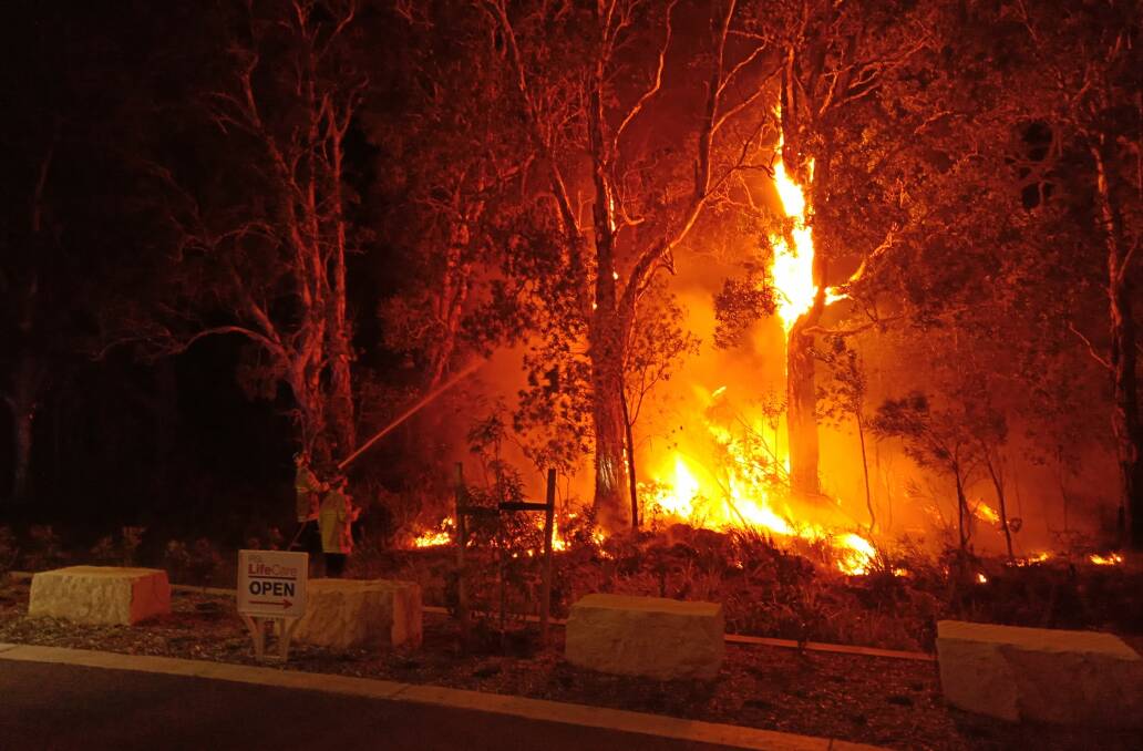 Close call: Fires at Lake Cathie on Tuesday night. Photo: Steve Drew.