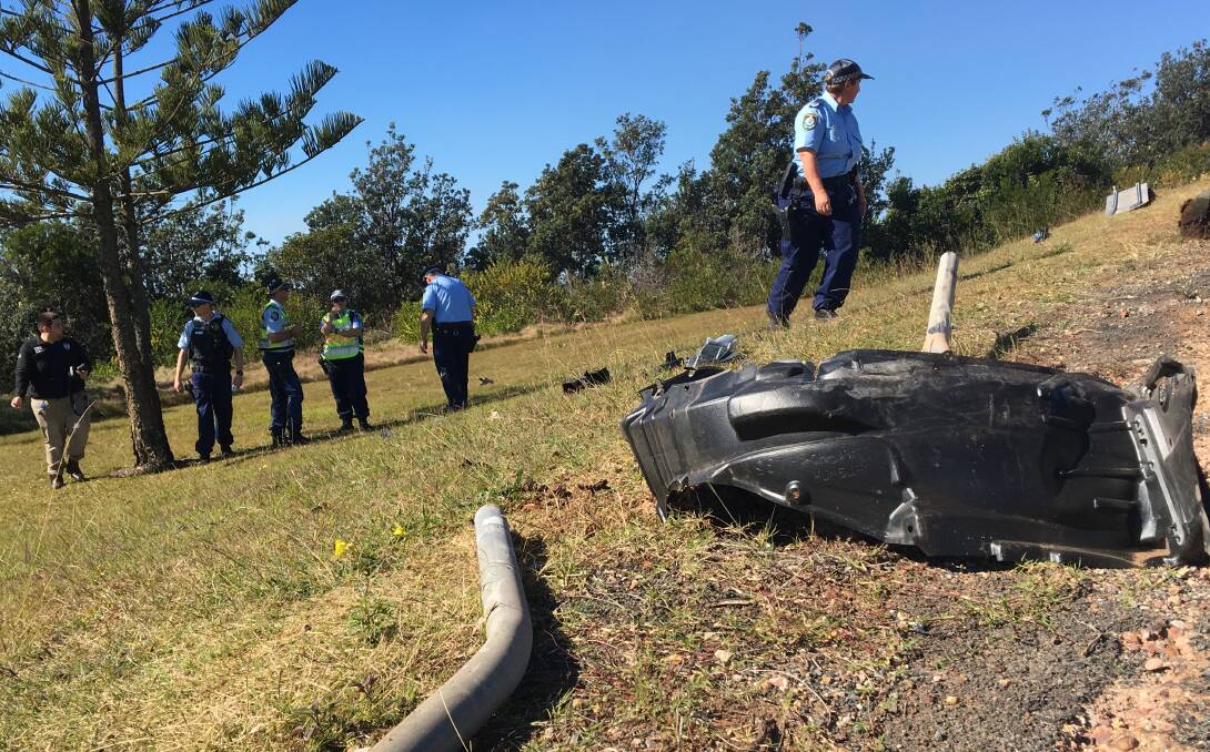 Police on scene after the vehicle plunged 40 metres into bushland over the Oxley Beach Reserve embankment. Photo: Tracey Fairhurst.