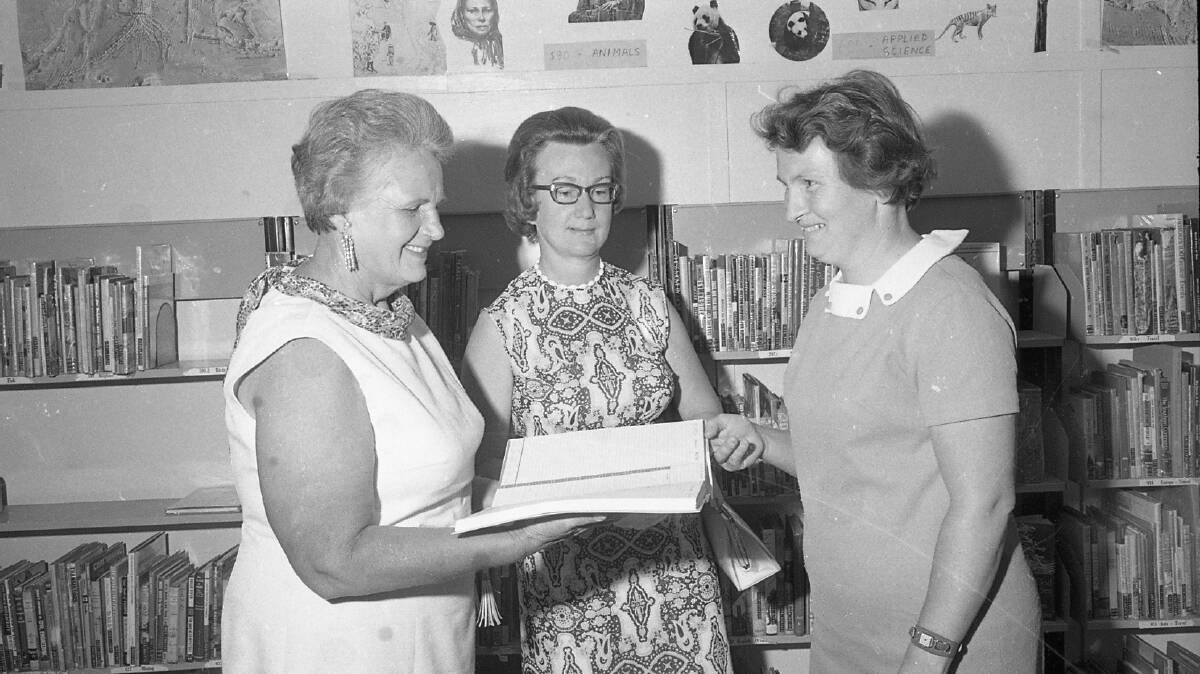 Quota Club president, Iris Keena,, (left), presenting the diary to Mrs Vera Kirkness, town librarian, with Mrs Jean Westerweller looking on, 1972