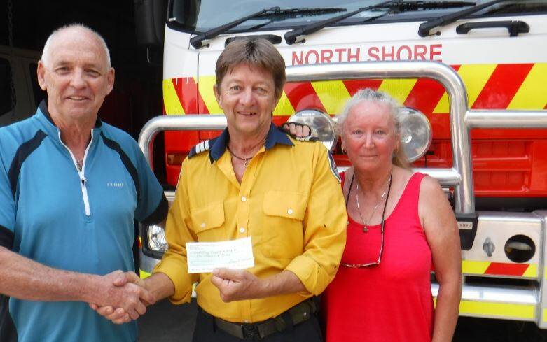 Thanks for everything: Port Macquarie Hastings Canoe Club's Greg Donaldson and Caroline Swan-Webber with North Shore RFS captain Kingsley Searle.