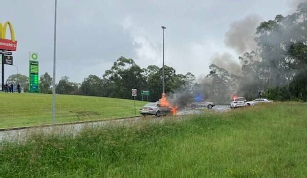 The vehicle on fire at the Port Macquarie highway intersection on December 31. Photo: Mid North Coast Police.