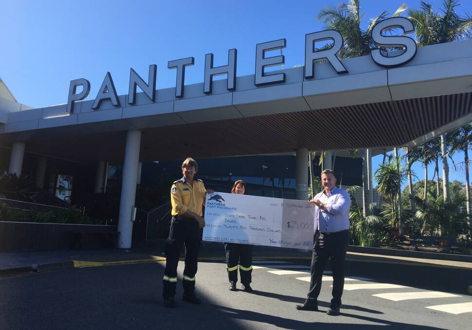 North Shore Rural Fire Brigade's Kingsley Searle and Lisa Hort with Panthers Port Macquarie CEO Russell Stockham.