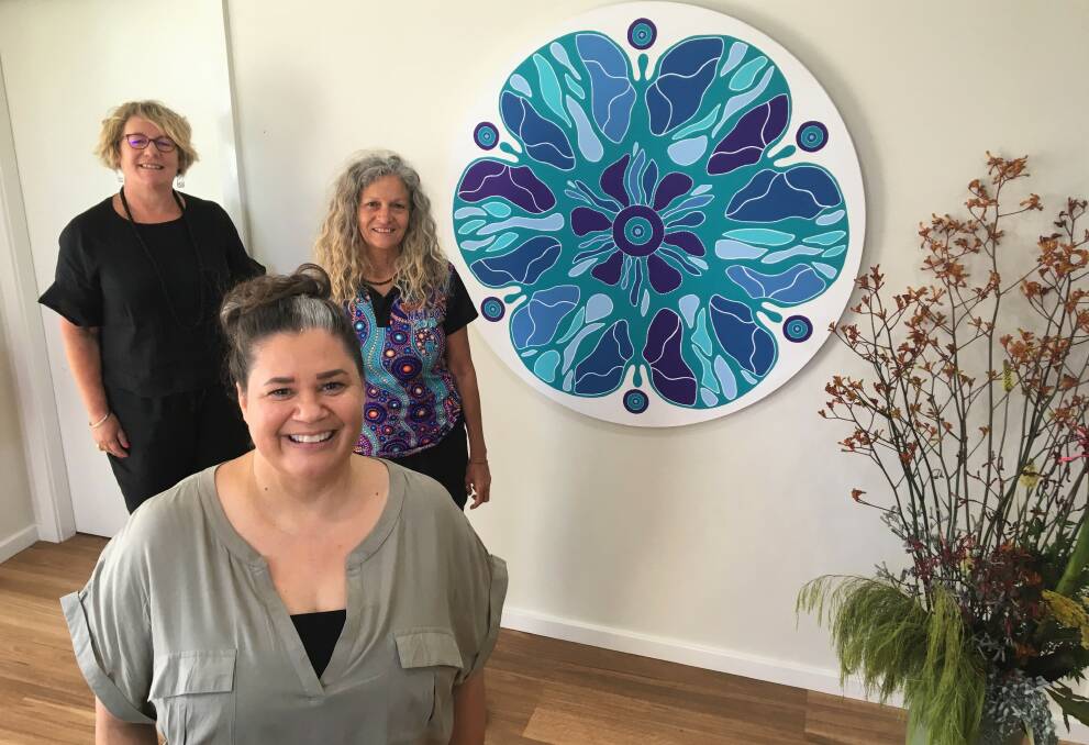 Women together: Artist Angela Marr-Grogan and her artwork Galbaan Wakulda joins Liberty CEO Kelly Lamb and Aunty Rhonda Radley.