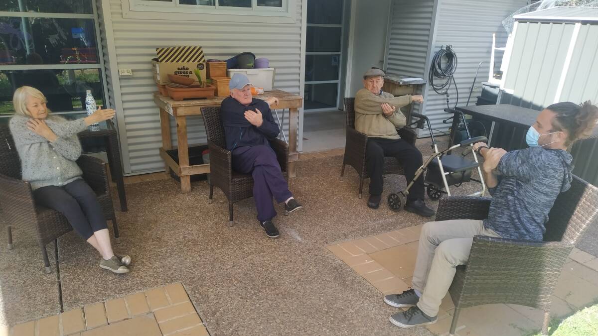 Omnicare Social Support Group regulars Marcia Kindred, Colin Adams and Ken Lewis join in an outdoor seated workout with staff member Douglas Ansell.