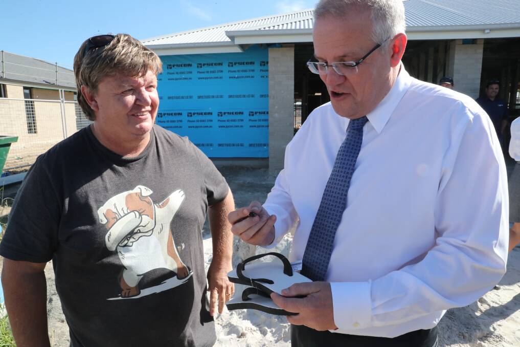 Harry Harris of Port Macquarie getting his thongs signed by Prime Minister Scott Morrison.