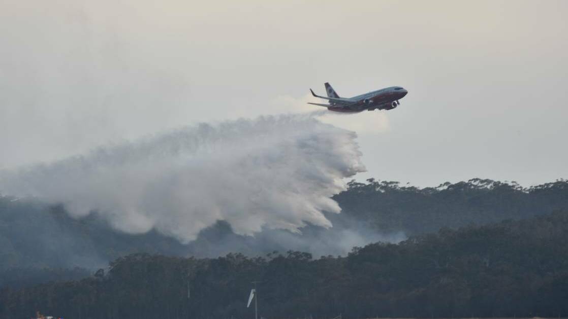Water bombed: The 737 large air tanker Marie Bashir makes her maiden water drop on the Lindfield Park Road bushfire. Photo: Rob Dougherty.