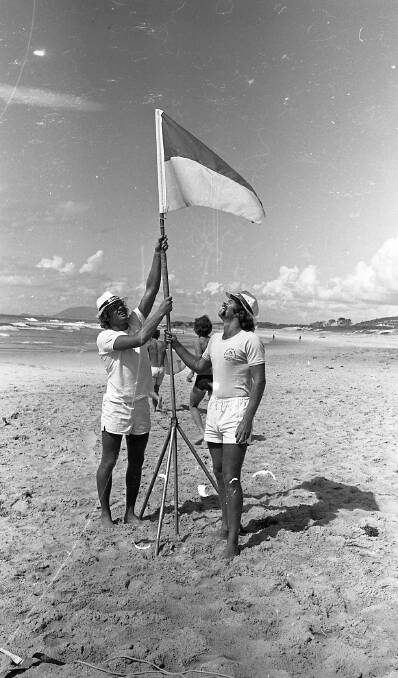 Mark Dingle and Norman Morgan plant the patrol flag at Lighthouse Beach, 1972