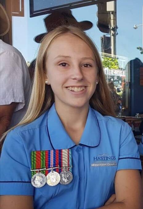 Kelsie Rayment wearing her family's medals at Anzac Day in 2019.