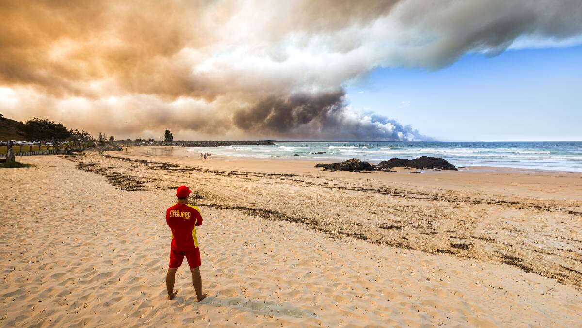 Lifeguard Brae Pettiford watches the drama from Lighthouse Beach. Photo: Ivan Sajko
