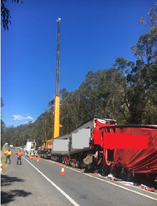 A crane has been called in for a salvage operation after four trucks were involved in a crash on the Pacific Highway near Telegraph Point. Photo: LiveTraffic