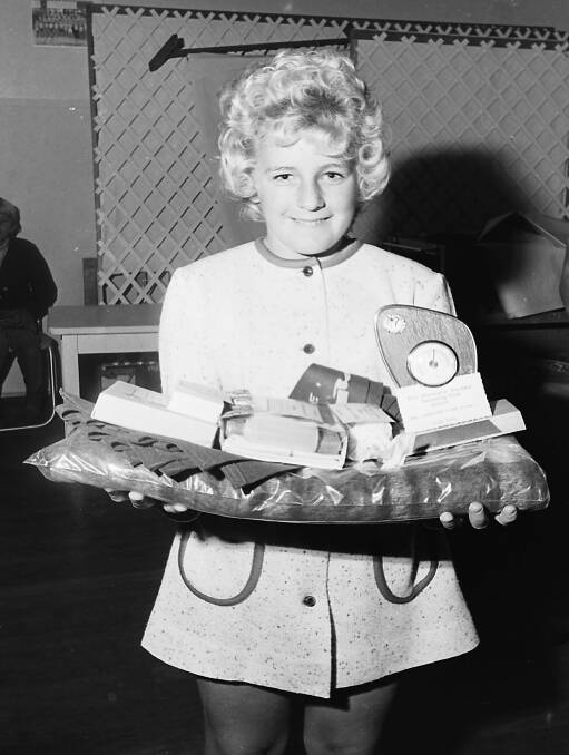 Julie Dunn with an armful of trophies at the Swimming Club presentation evening, 1971