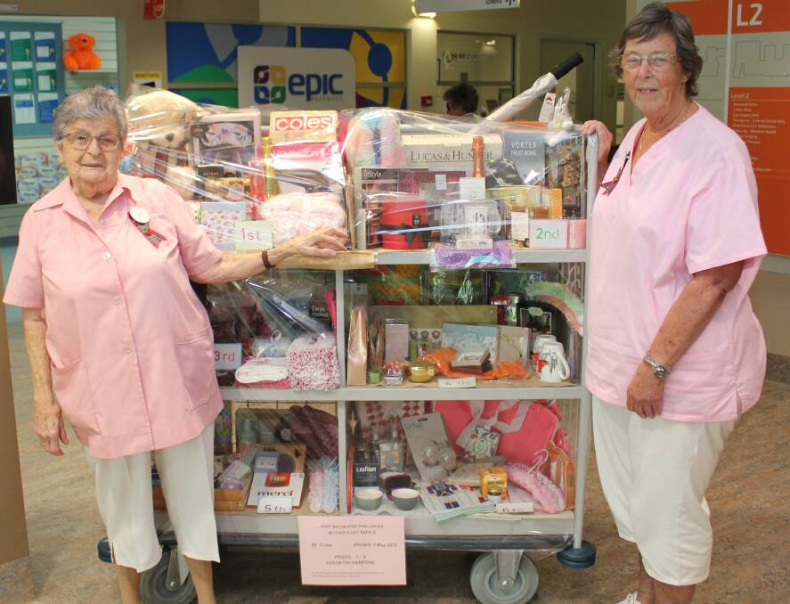 Big raffle: Port Macquarie Pink Ladies Joyce Dean and Wendy Newport with the Mother’s Day prize packages being raffled at Port Macquarie Base Hospital.