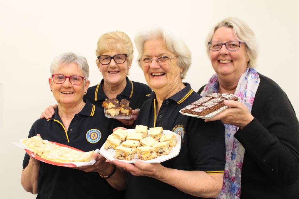 Slice of home: Port Macquarie Evening CWA members Gail Hassall, Fay Bischoff, Gay Gowan and Julie Adams serve up some treats for their mental health awareness campaign.