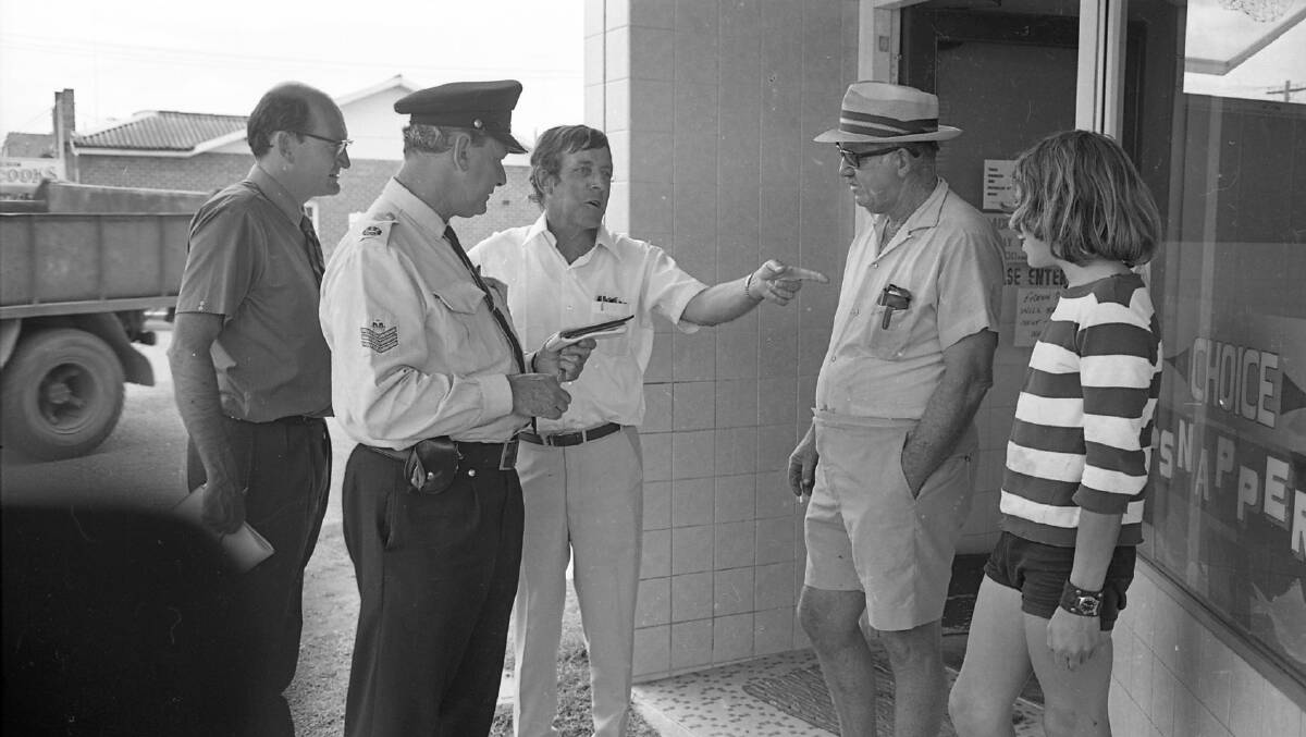 Sgt. Bob Plain discusses the flotilla disaster with Stuart White (centre), Merv Radley and Peter White, 1972