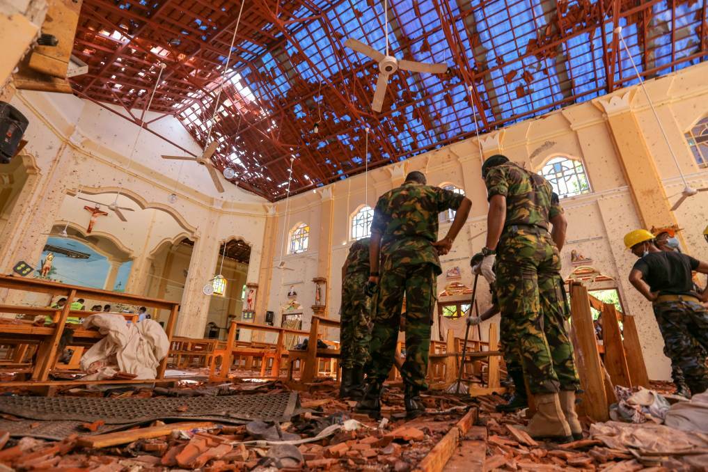 Sri Lankan soldiers inspect the damage inside St. Sebastian's Church where a bomb blast took place in Negombo, Sri Lanka. Photo: Bloomberg