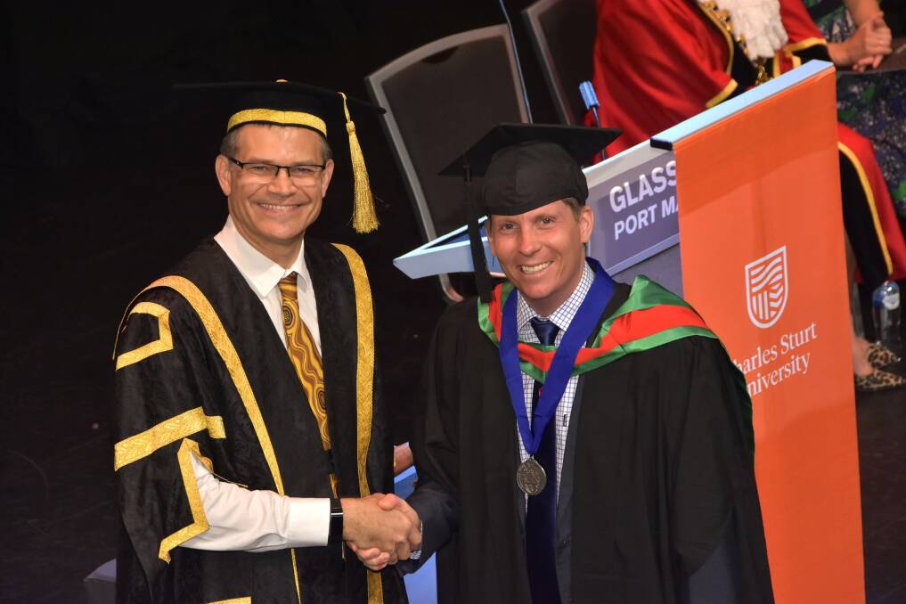 HIGH ACHIEVER: Charles Sturt University Vice-Chancellor Andrew Vann with graduate Robert Jeffries. Photo: Supplied/CSU.