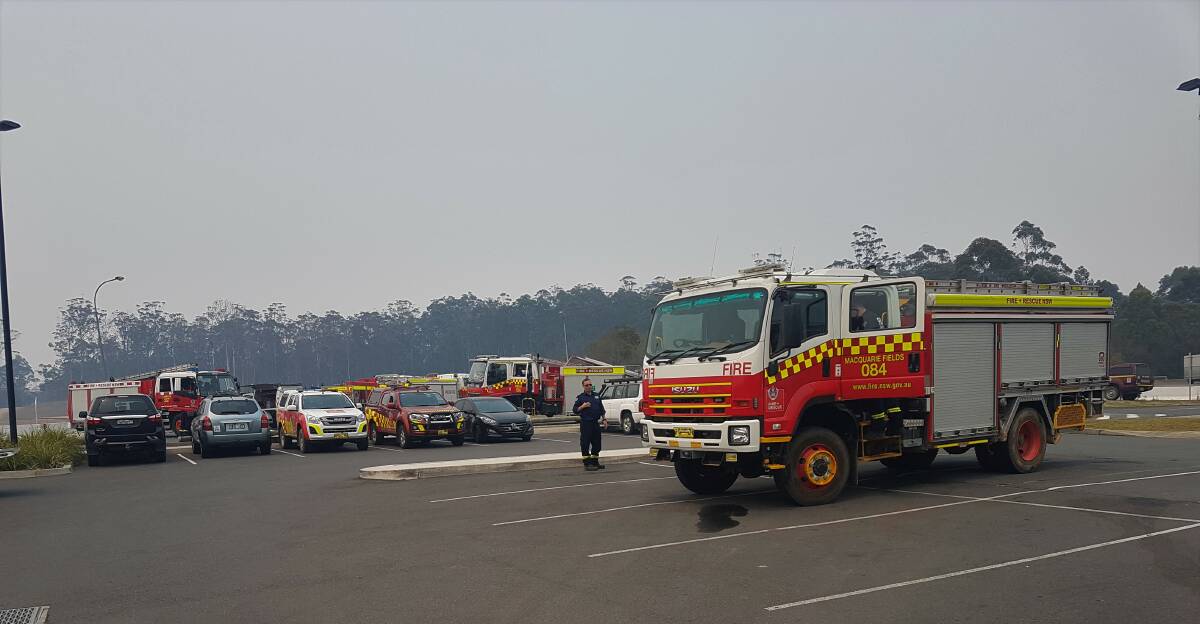 REFUEL AND REST: Firefighters taking a break at the marquee in Port Macquarie.