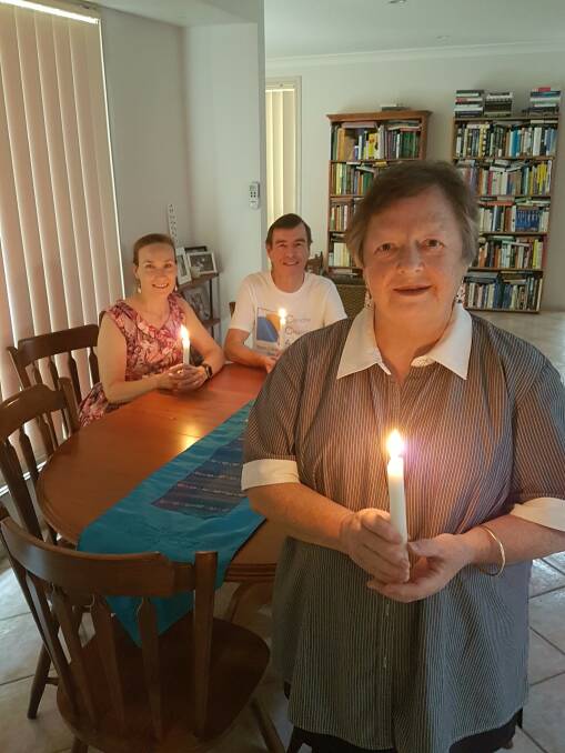 Earth Hour Dinner: Community candle light dinner with Kerri-Ann Jones (standing), Angela Frimberger and Mick Lyons.