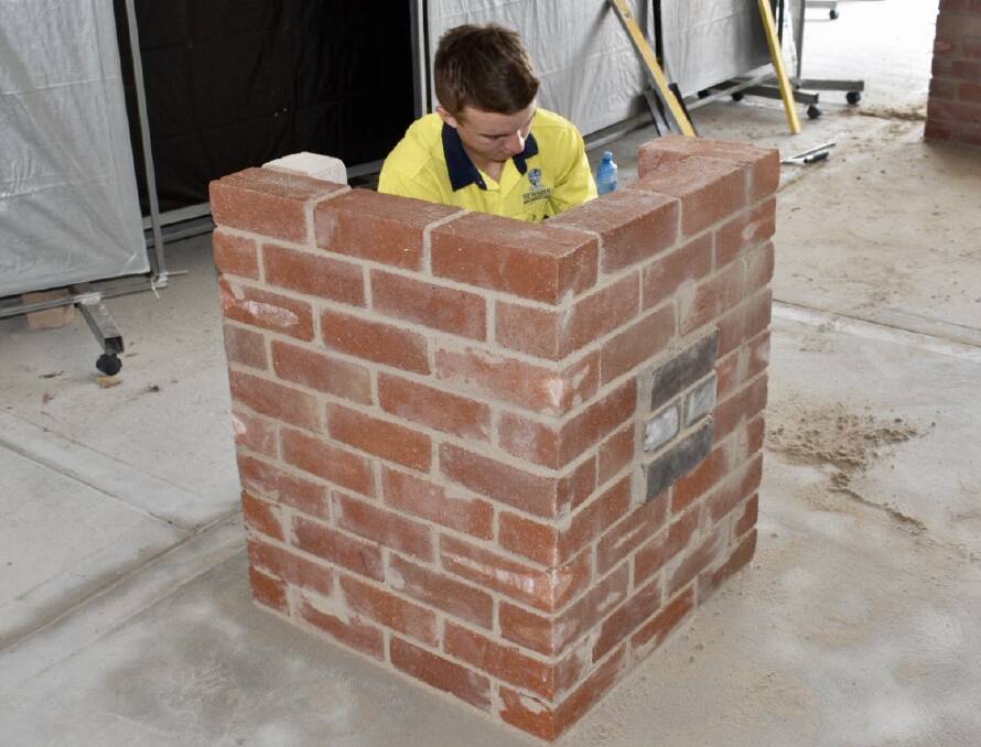 ON THE JOB: A student contests the bricklaying category of the event. Photo: Supplied/Newman College.
