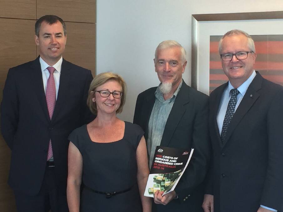 LIFE'S WORK: John Walker with Minister for Justice Michael Keenan, the then head of the Aust Crime Commission Chris Dawson and project manager Mandy Carter at the launch of Costs of Serious and Organised Crime in Australia report, Dec 2015. 