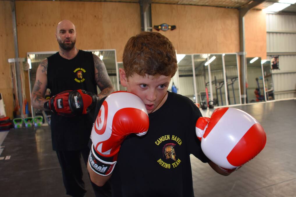 RISING BOXING ATHLETE: Hastings teenager Cameron Weightman with coach James beard.