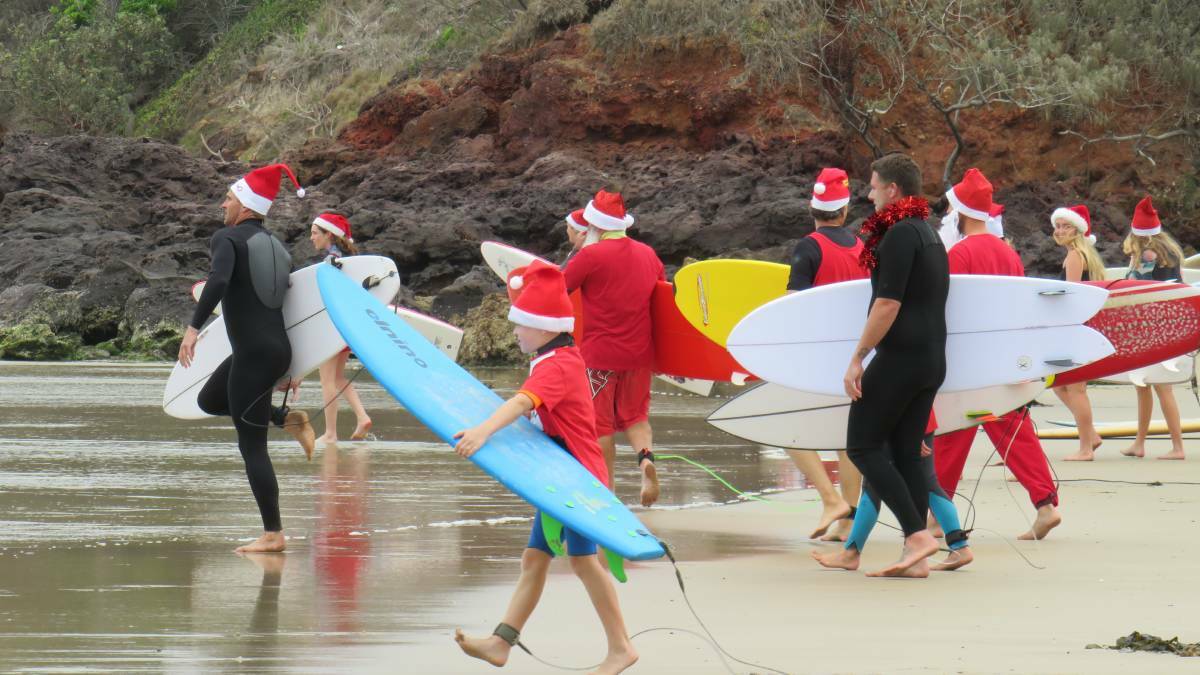 CHRISTMAS CELEBRATION: Surfing santas at Rainbow Beach in 2019.