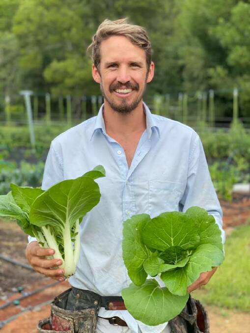 HAPPIER TIMES: James Smith with some fresh produce before the floods. Photo: Sohip Farm.