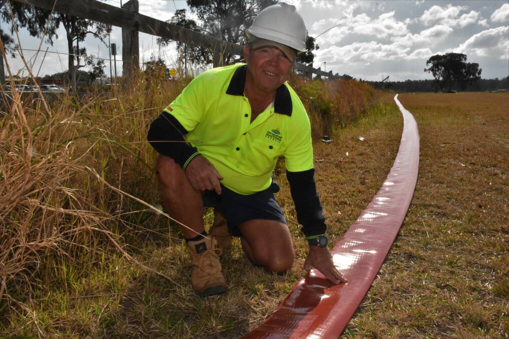 PIPING PLAN: Port Macquarie-Hastings Council plant operator Wayne Mulley installing pipeline near Port Macquarie Airport.
