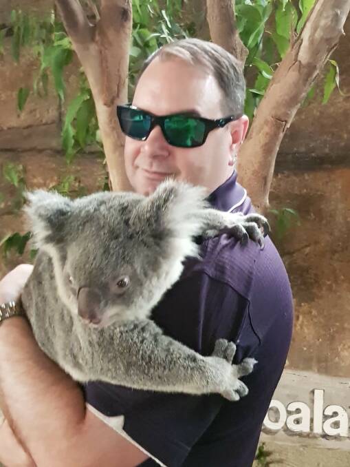 CUDDLY PATRON: Kendall resident Brian Rowe with a koala at Billabong Zoo.