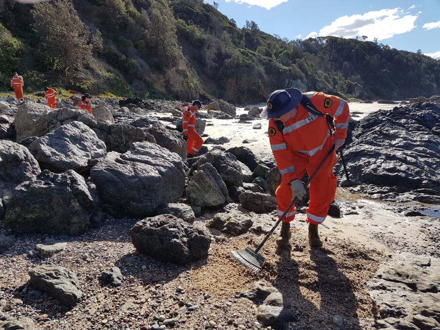 Search line: Port Macquarie SES volunteers undertaking a search operation at Rocky Beach.