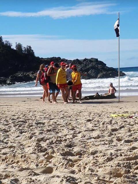 Beach incident: A surfer treated at Flynns Beach. Photo: Supplied