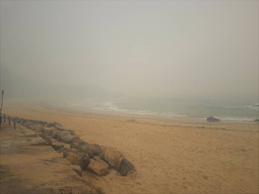 SMOKE HAZE: Smoke blankets Flynns Beach in Port Macquarie.