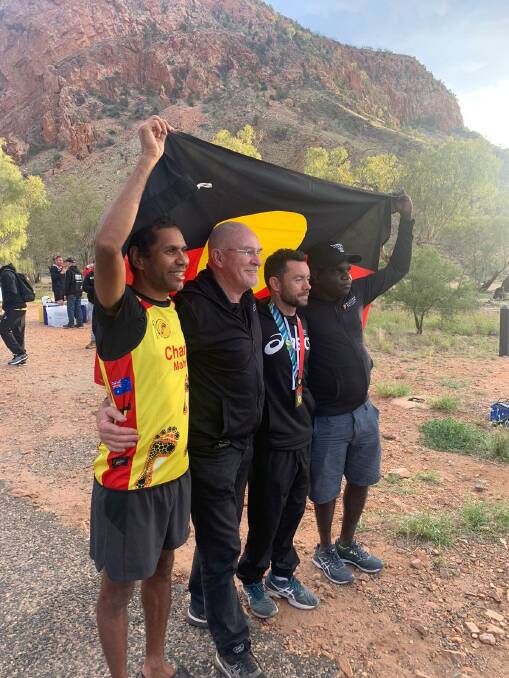 SUPPORT THE NEXT GENERATION: Charlie Maher with IMF founder Rob de Castella and Ethan Mulholland, Juan Darwin in Alice Springs. Photo: Supplied/IMF.