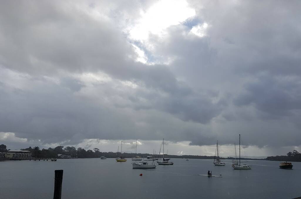 Heavy sky: Rain falling near Port Macquarie's North Shore on June 25.