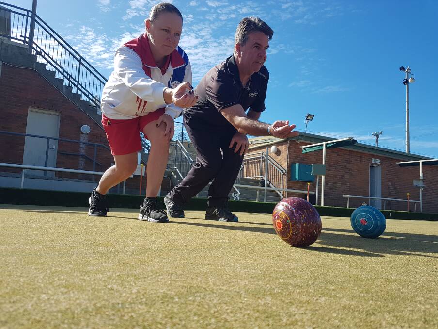 Roll on: Port City ladies single champion Kylie Hardy and bowls coordinator Phil Baker.