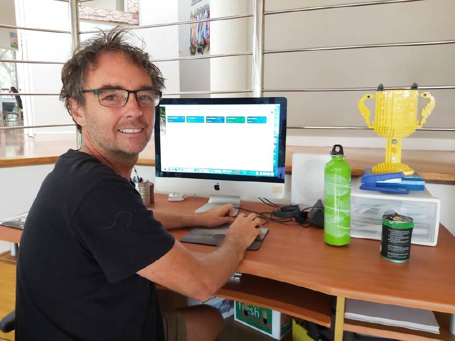 DESK READY AT HOME: Lloyd Godson directing school work from home. Photo: Supplied.