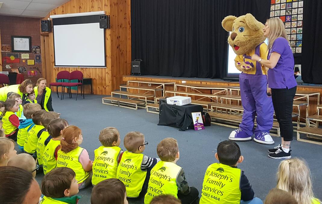 ENGAGING: Students learning about safety with Ditto the lion.