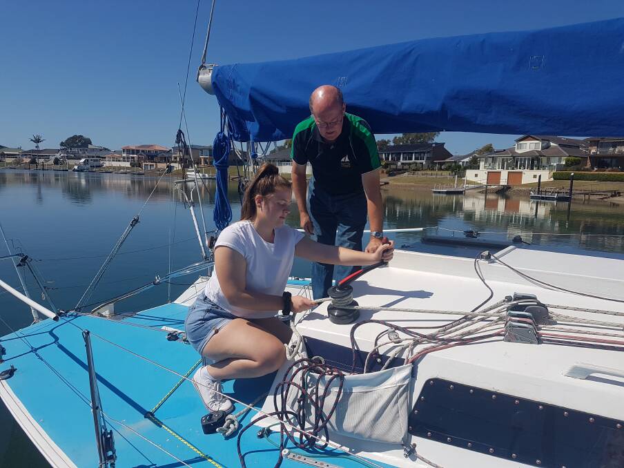 RIGGING: Madisan Rogers with Port Macquarie Sailing Club secretary Stuart Symons.