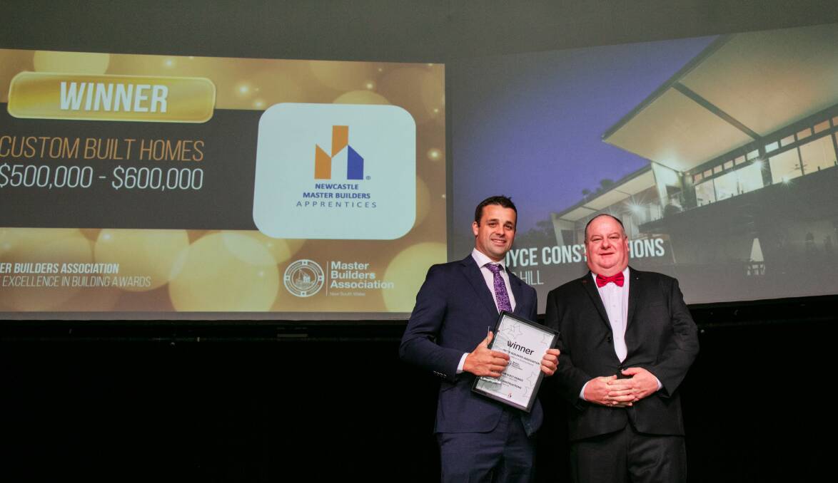 CUSTOM HOMES: Joyce Constructions owner and director Mitch Joyce collects an award at the Excellence in Building Awards. Photo: Supplied.