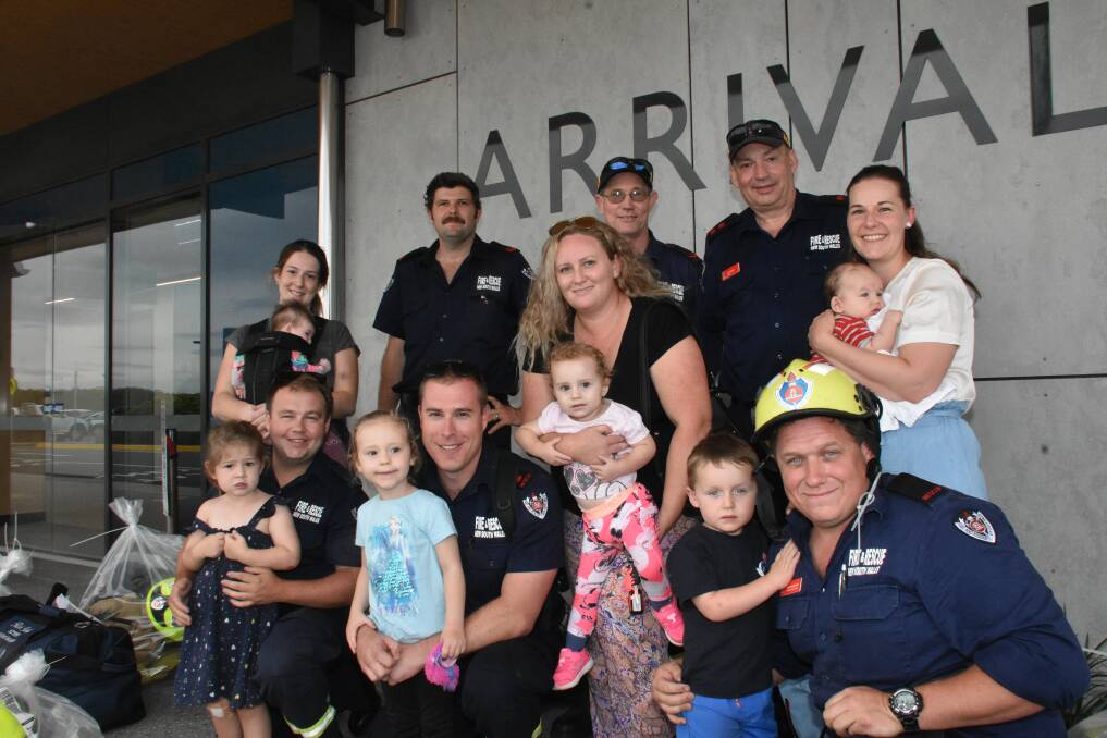 BACK HOME: Firefighters return to Port Macquarie families after the seven day deployment.