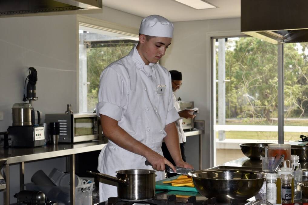 ON THE JOB: Newman College students tackling the commercial cookery section. Photo: Supplied/Newman College.