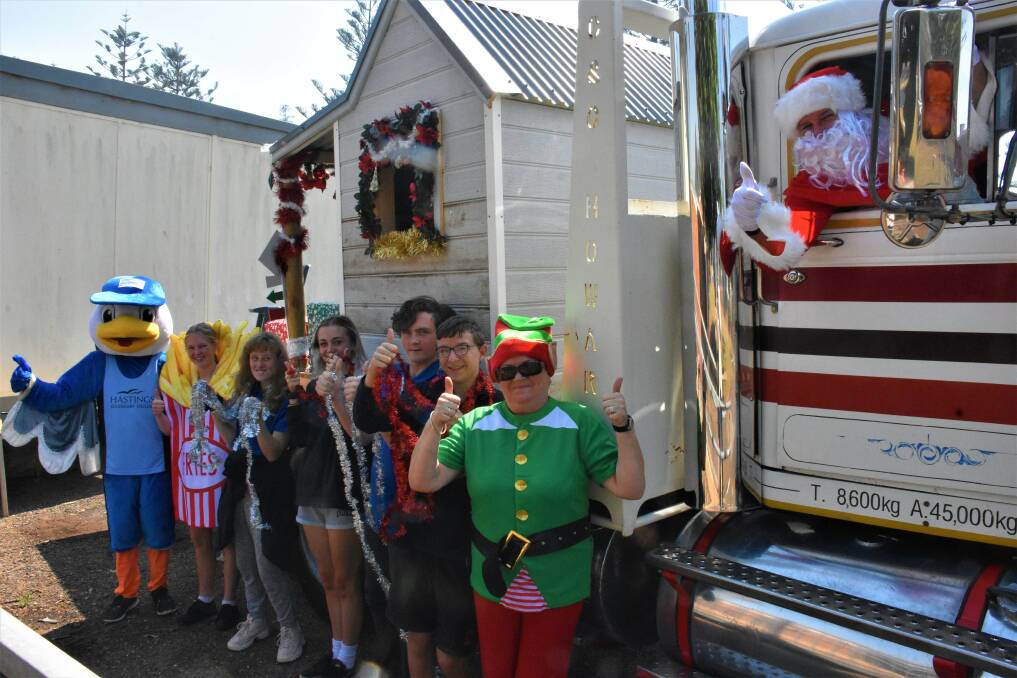 FLOAT BUILDERS: Hastings Secondary College students working on the Santa House parade float in Port Macquarie with mascots and Santa (Ian Ross).