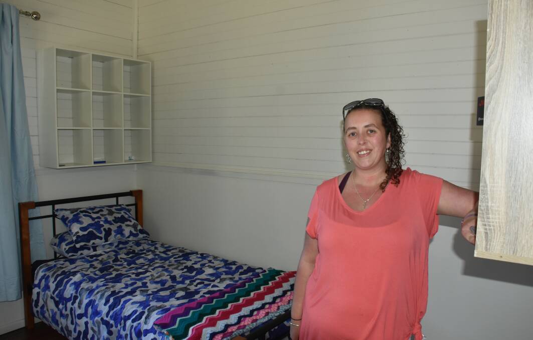 VOLUNTEER GUARDIANS: Amy Ward in a repainted room with donated bed.