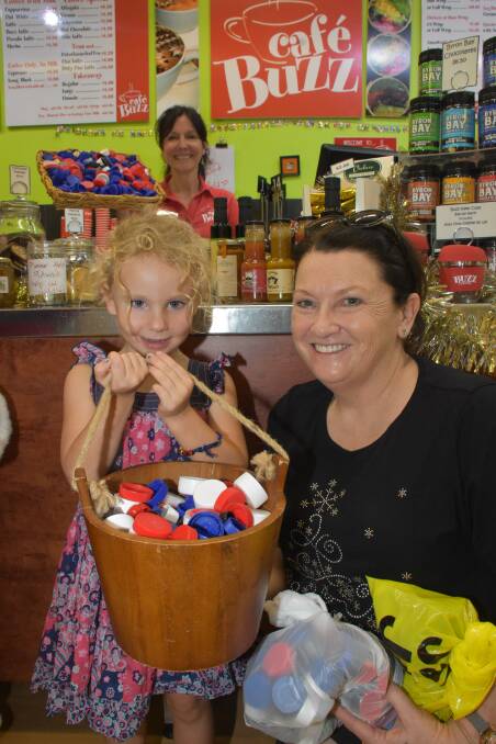 RECYCLING PLASTIC: Morgan Marlowe, 3 with teacher Leah Roberts and Cafe Buzz owner Vicki Brady.