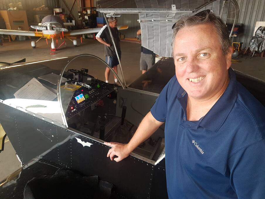 FLYING HIGH: Mike Bullock with some new equipment installed in the Batplane.
